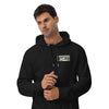 Man wearing a dark gray hoodie with a logo on a white background