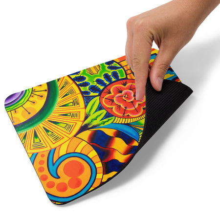 Colorful mouse pad featuring vibrant psychedelic, multicolored artwork a hand holding it on a white background