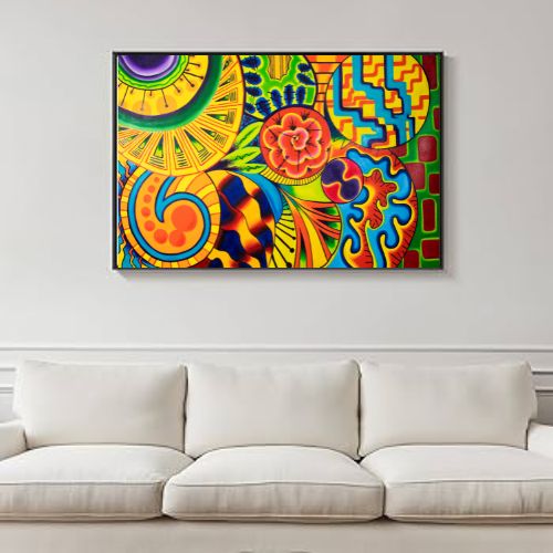 A colorful abstract wall art print with bright yellow, green, blue, orange, and red patterns, displayed above a white sofa in a living room setting.