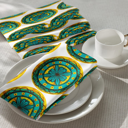 cloth napkins with a repeating circular mandala design in yellow and brown earthen tones and turquoise