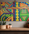Colorful abstract geometric painting on a wall above a wooden shelf with plants.