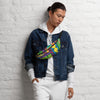 Person wearing a colorful fpsychedelic art anny pack against a white brick wall