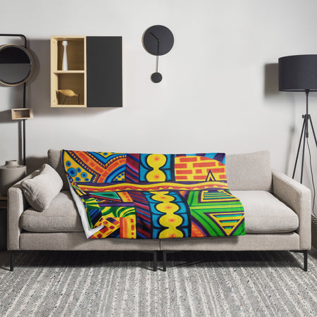 Colorful abstract, psychedelic patterned blanket with vibrant colors draped over a living room couch 