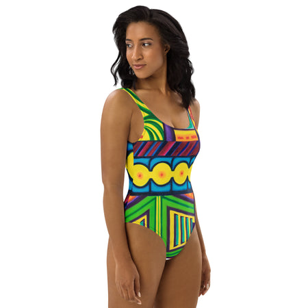  woman wearing an original art one piece womens swimsuit with a multicolored all over psychedelic print of geometric shapes