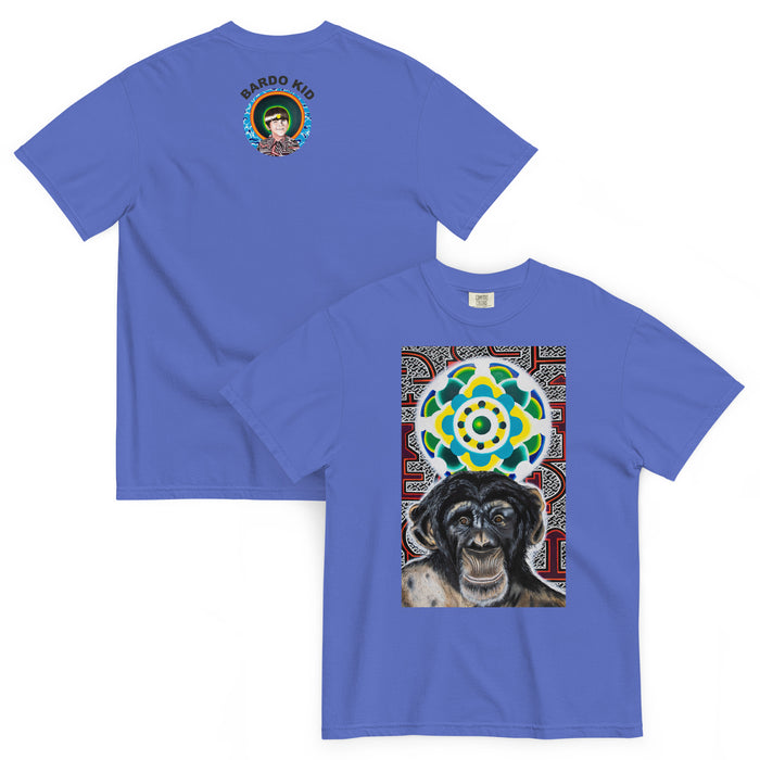 light blue t-shirt with a young chimpanzees face in front of a turquoise, green, and yellow psychedelic mandala with a background illustrated by pulsating geometric red and purple forms